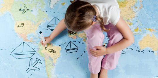 Little Girl Sitting on Map