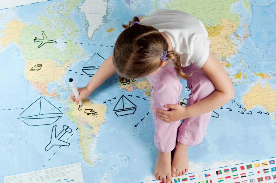 Little Girl Sitting on Map