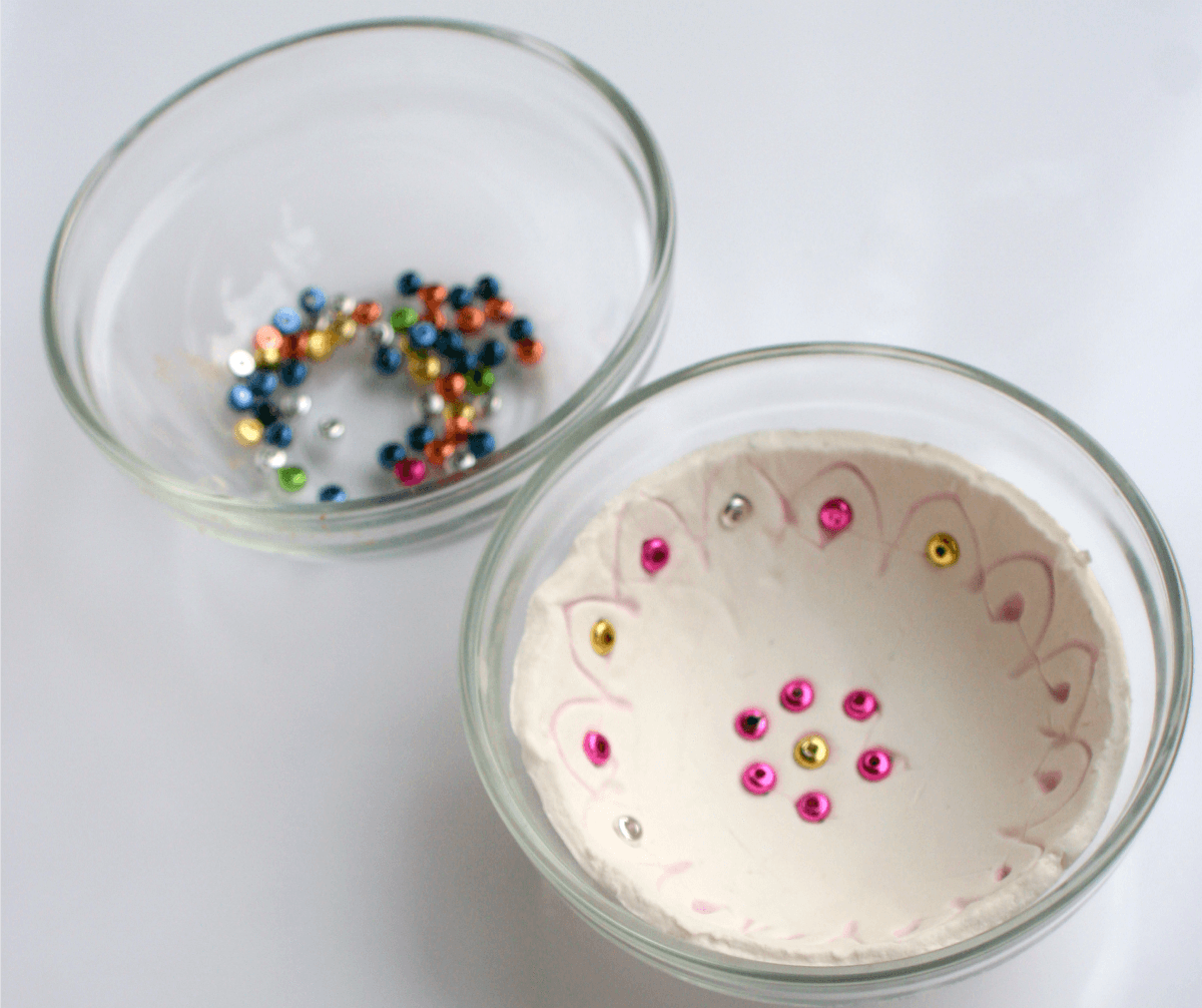 Step 5 - make a clay diya with kids, shape the clay and add beads