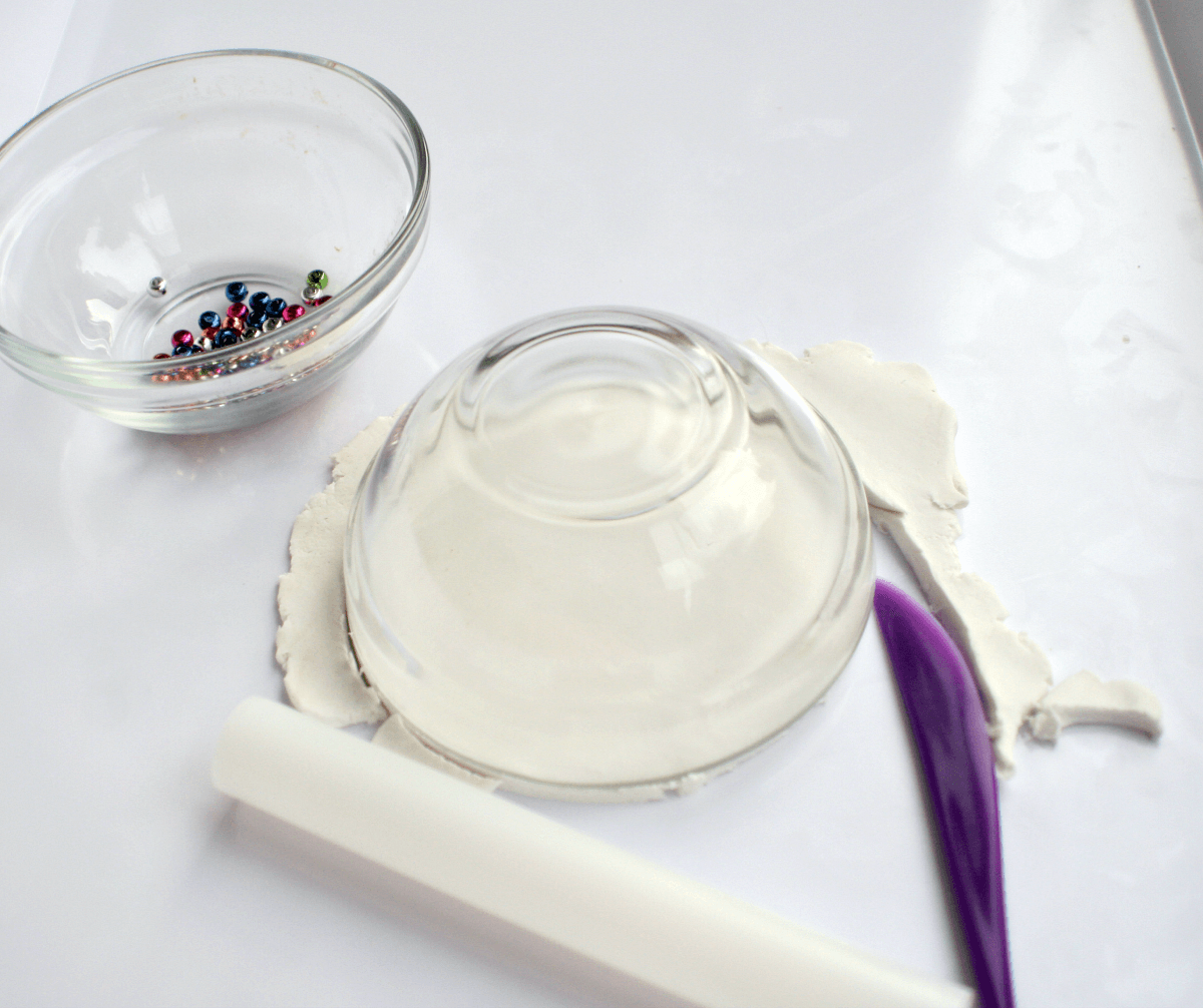 Step 2 - make a clay diya, cutting clay around a bowl
