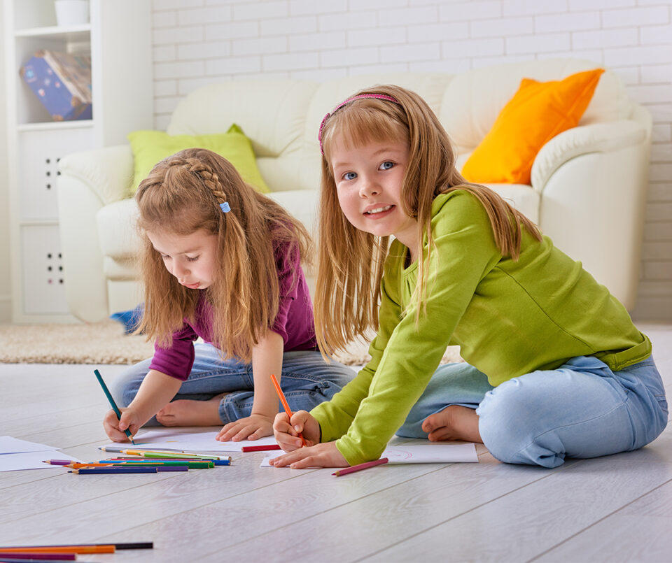 Girls coloring on floor