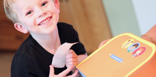 Young Boy Interacting with Little Passports Early Explorers