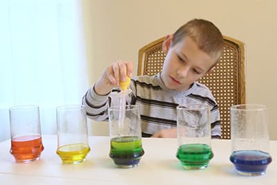 use the turkey baster to layer your colored water into the empty glass