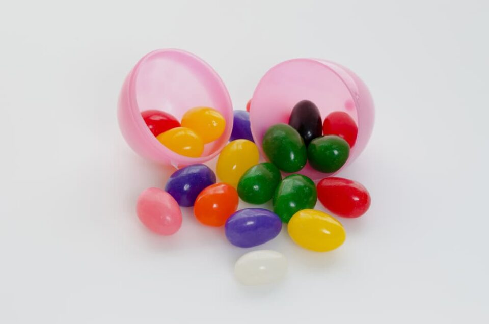 Jelly beans spilling out of an open pink plastic egg