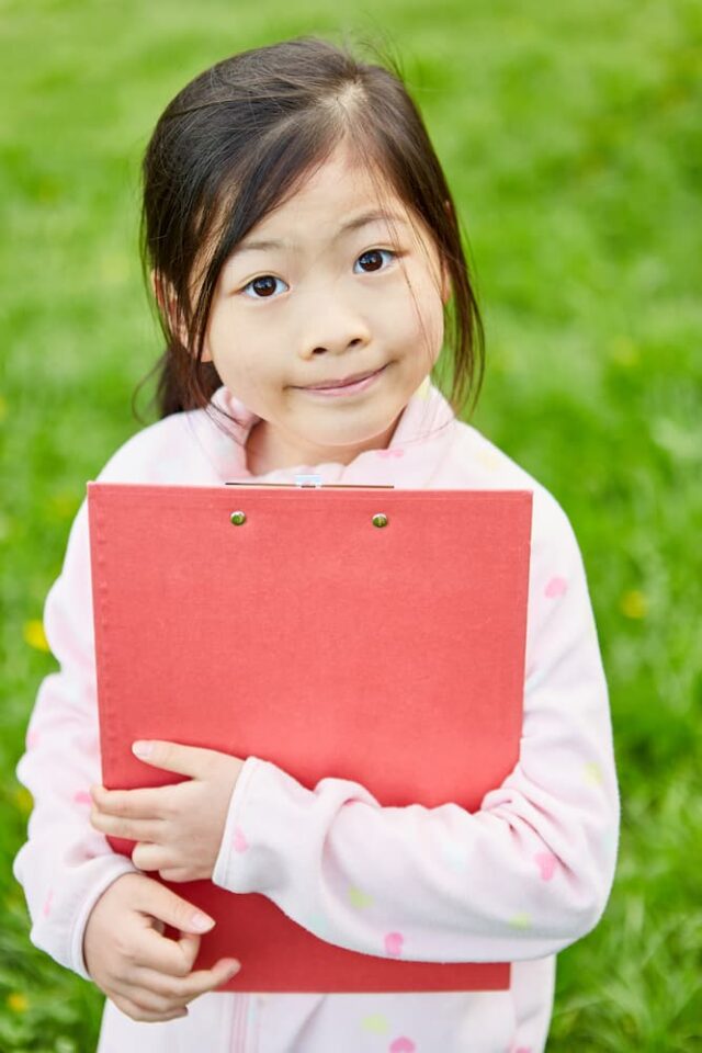 Girl holding clipboard for scavenger hunt