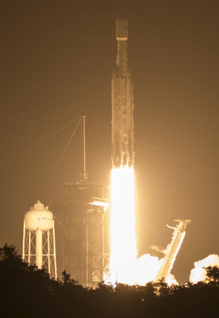 A Falcon Heavy rocket launching satellites into space
