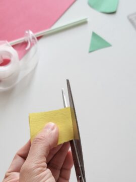 Person cutting out pieces of a straw rocket