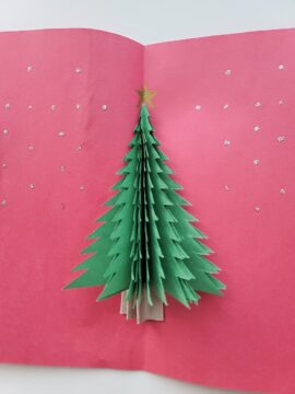 Interior of pop-up Christmas tree card decorated with glitter glue stars
