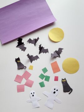 Ghosts, bats, cats, moons, and other Halloween images cut out of construction paper