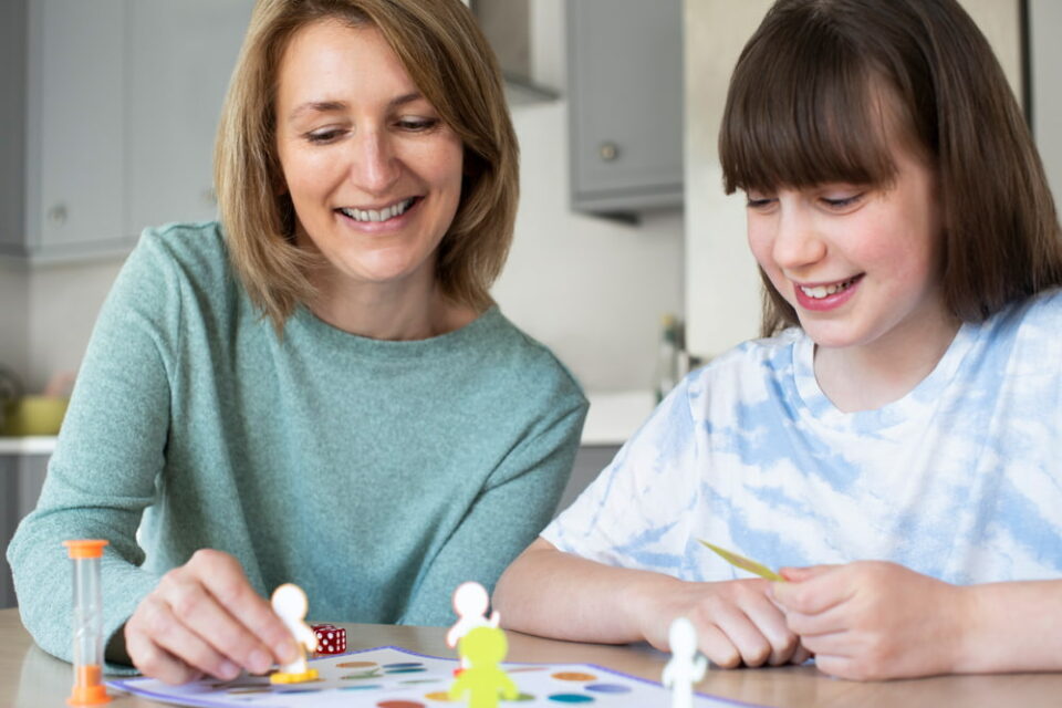 Mother and daughter playing board game