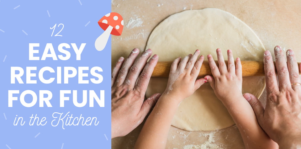 A child and adult work together to roll dough with a rolling pin on a table