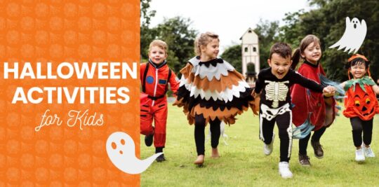 A group of children dressed in various Halloween costumes hold hands