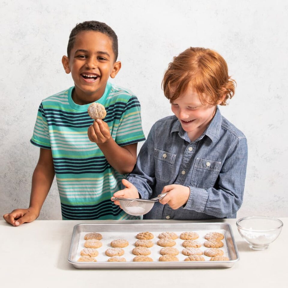 Two children making Egyptian spice cookies