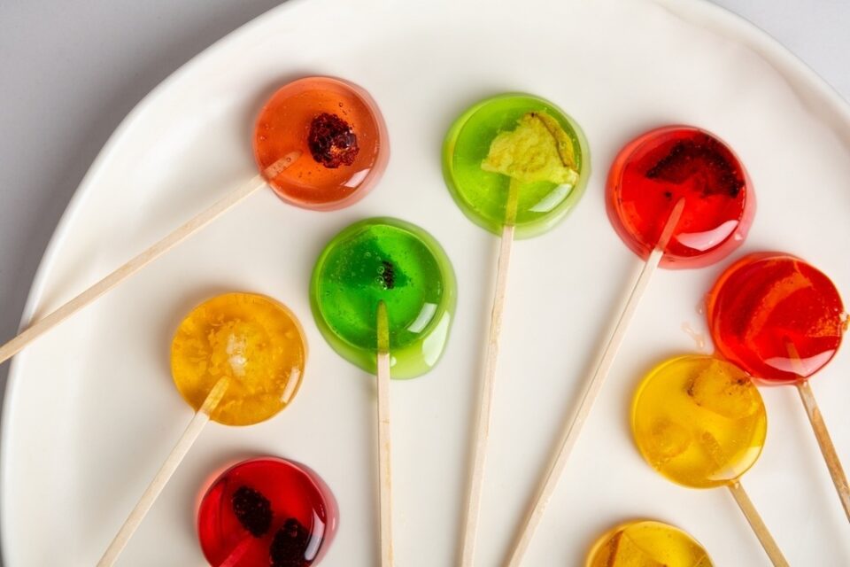 A plate of homemade lollipops in various colors.
