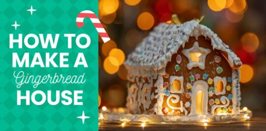 A homemade gingerbread house adorned with icing, lights, and candy.