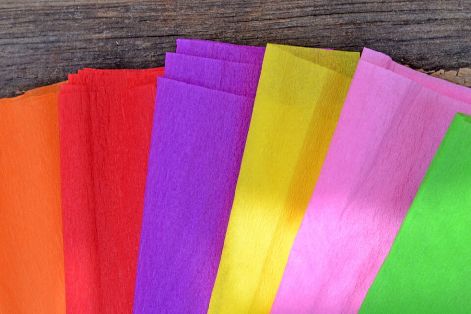 Several colors of tissue paper laid out on a table