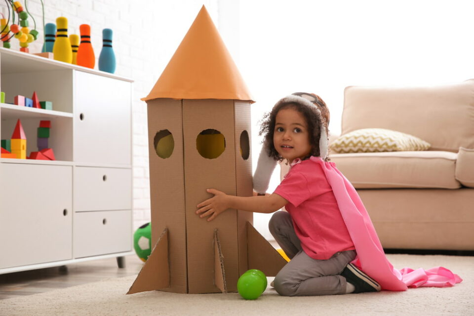 A-child-playing-with-a-cardboard-spaceship