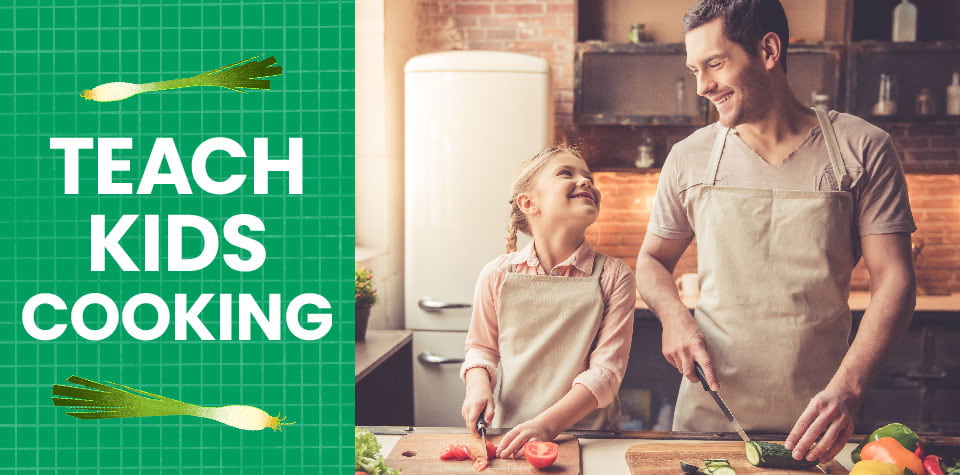 A girl and her father chop vegetables in the kitchen