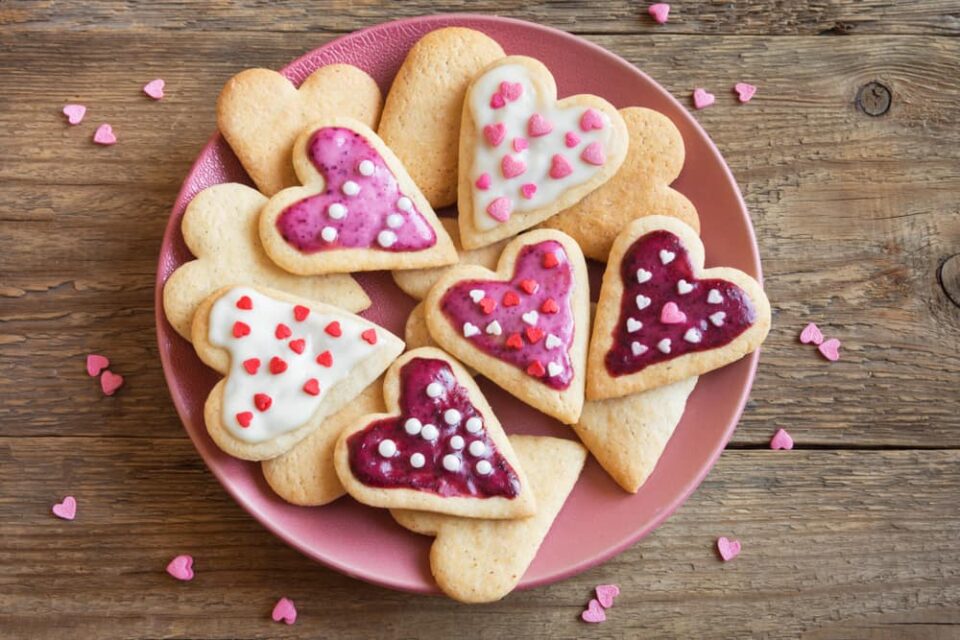 Heart-shaped-cookies-with-pink-and-white-icing-on-a-pink-plate
