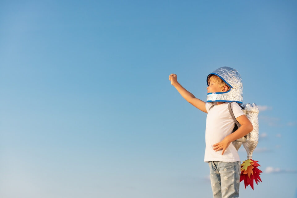 Young-child-standing-outside-dressed-in-astronaut-costume