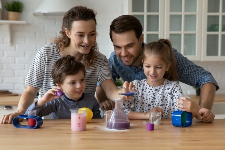 A family doing a science experiment in the kitchen.