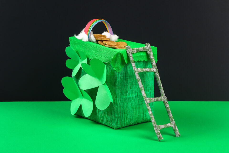 A green leprechaun trap on a table.