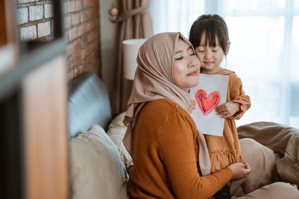 A mother hugging her daughter after getting a homemade valentine