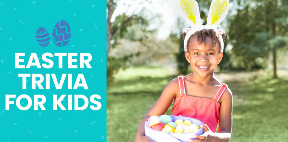 A young girl wearing bunny ears and holding a basket of Easter eggs