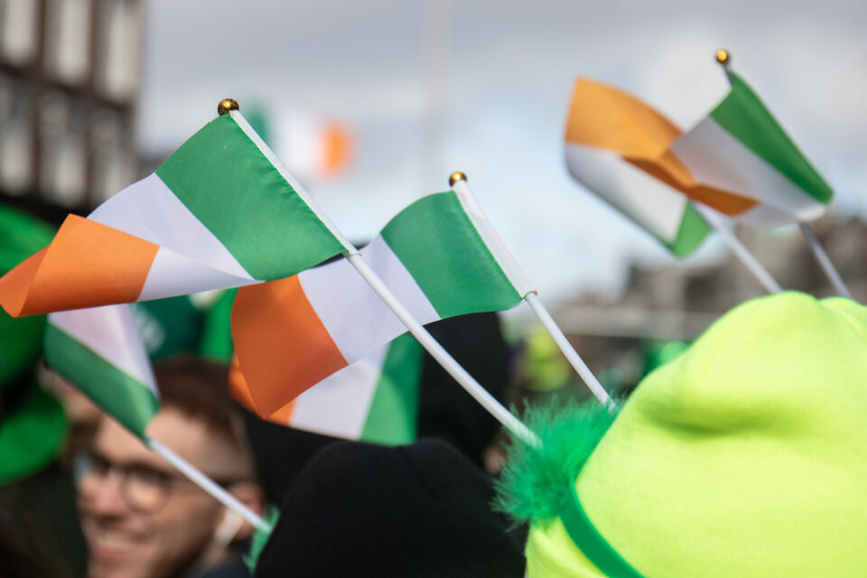 People holding small flags of Ireland