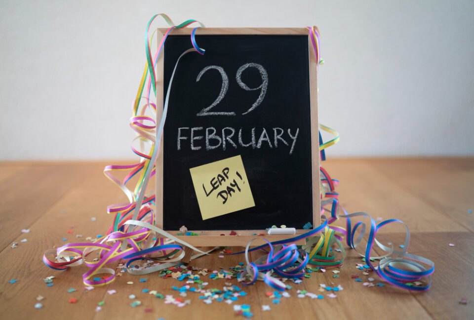 A small chalkboard with “February 29” written on it and streamers all around.