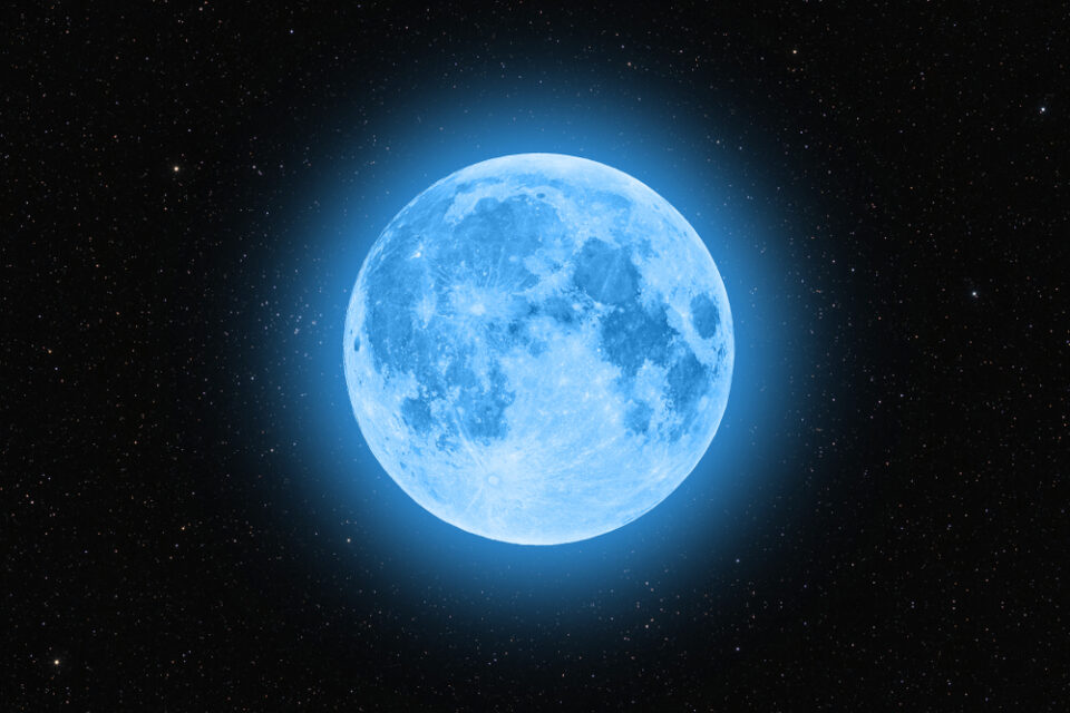 A blue Moon against a starry sky.