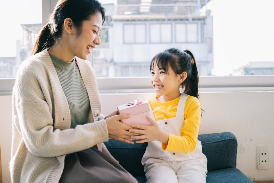 A mother giving her child a birthday gift