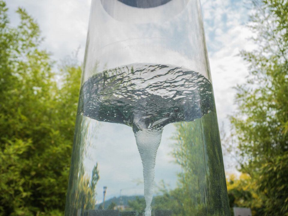 A tornado in a glass cylinder sitting outside