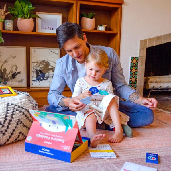 Dad and kid playing with HOMER explore feelings kit