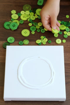 How to make a button wreath with Little Passports step 1: Apply glue in a circular shape