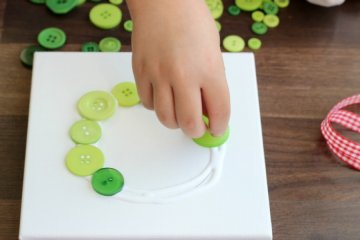 How to make a button wreath with Little Passports step 2: Place buttons onto glue circle