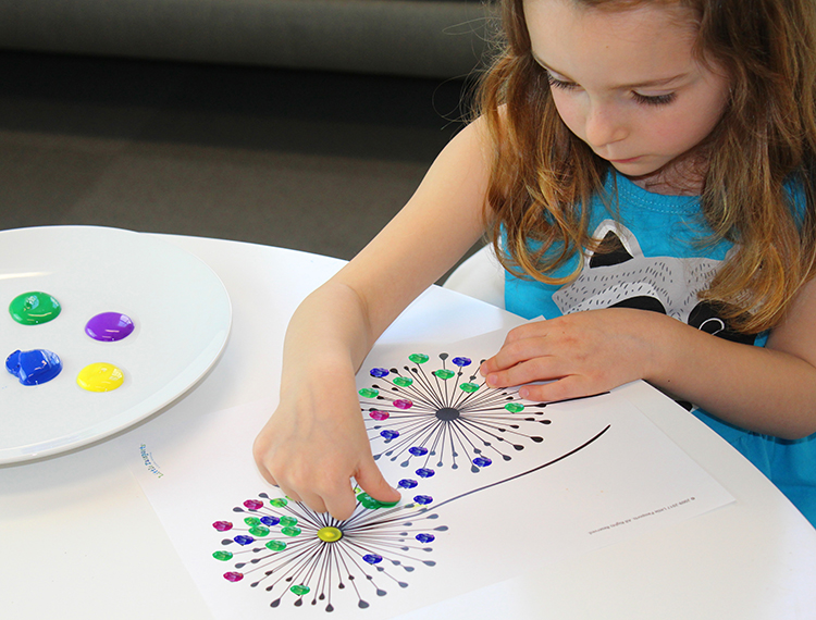 Child painting on a dandelion template