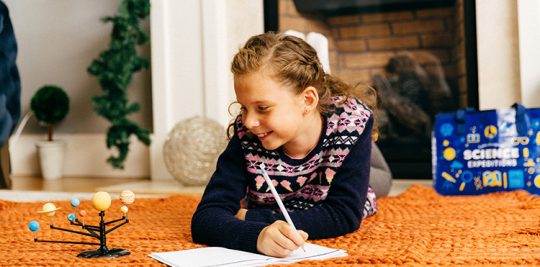 Girl playing with solar system model Science expeditions