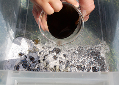 Add colored water to baking soda mix