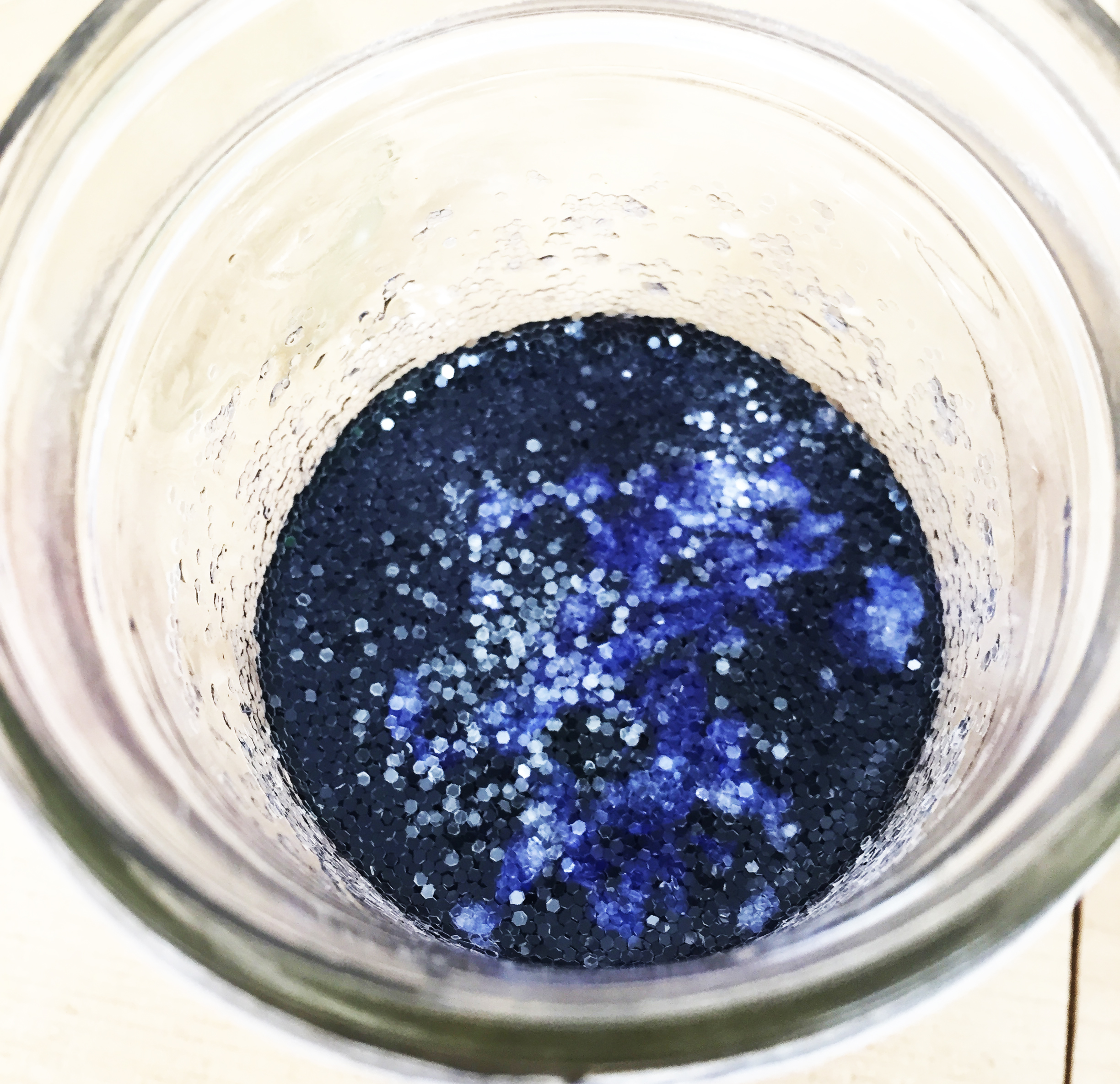 combine glitter, water, and food coloring and mix