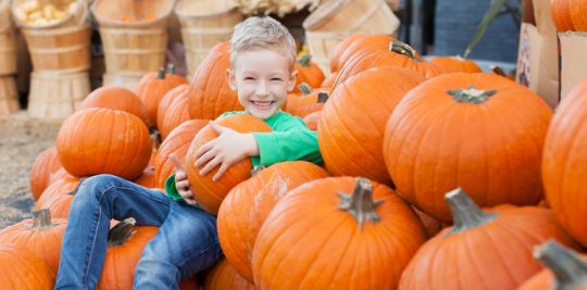 kid with pumpkin