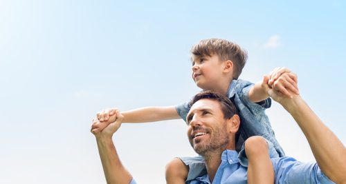 father with son on shoulders