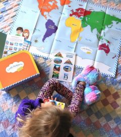 UGC - Child with Early Explorers suitcase and world map