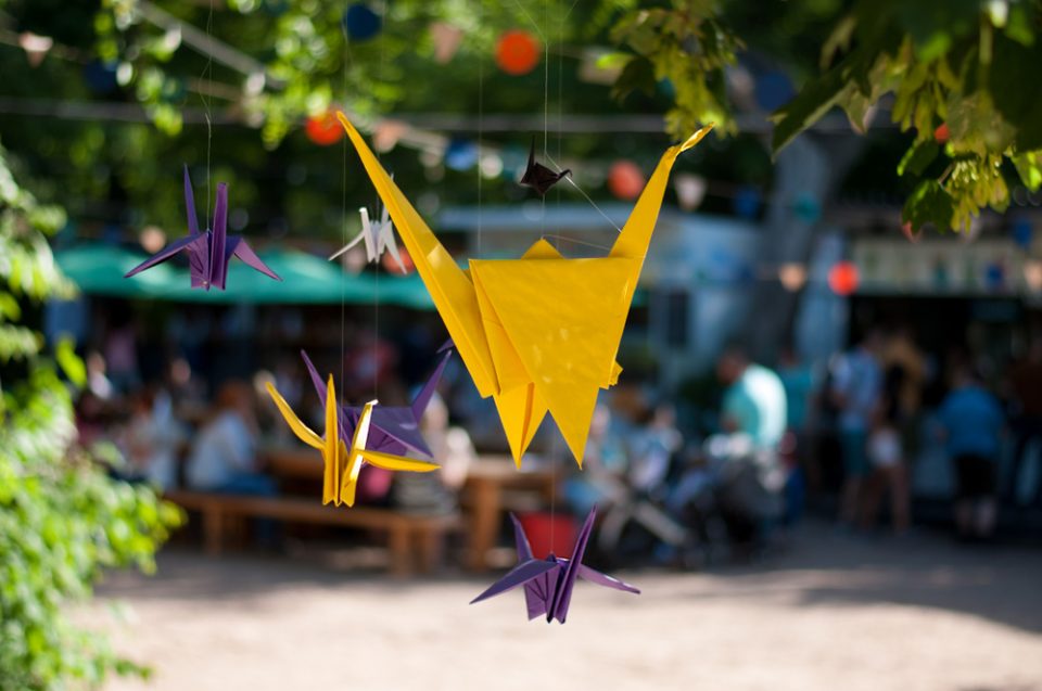 Origami cranes hanging from a tree in Japan
