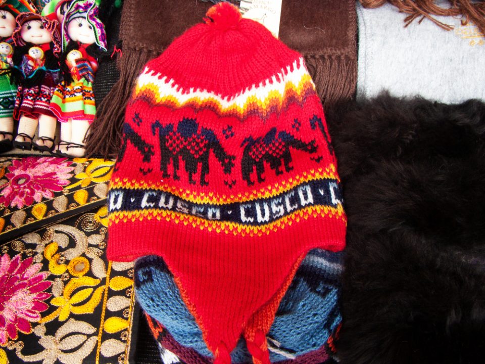 Red chullo with llama design in market