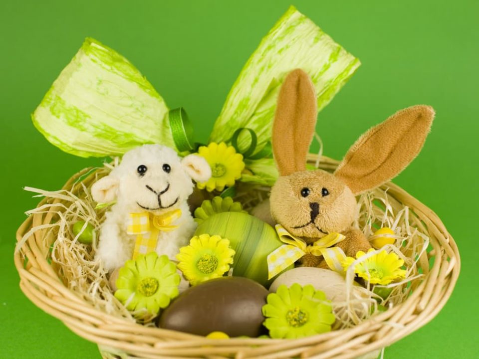 Easter basket ideas for kids - plushies, eggs, flowers, and more in a wicker basket