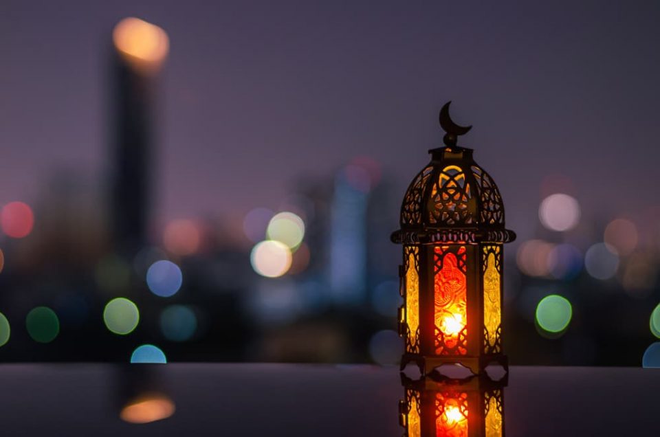 A Ramadan lantern in a city at dusk